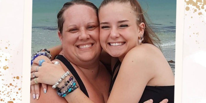 Sarah and her daughter Cassidy hugging on the beach.